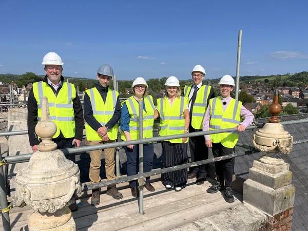 A group of people in hi viz jackets on top of the scaffolding at Ashbourne Methodist Church