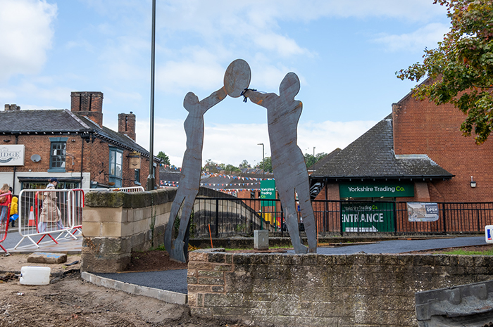 Corten steel statues form an archway feature over the new entrance to Shrovetide walk